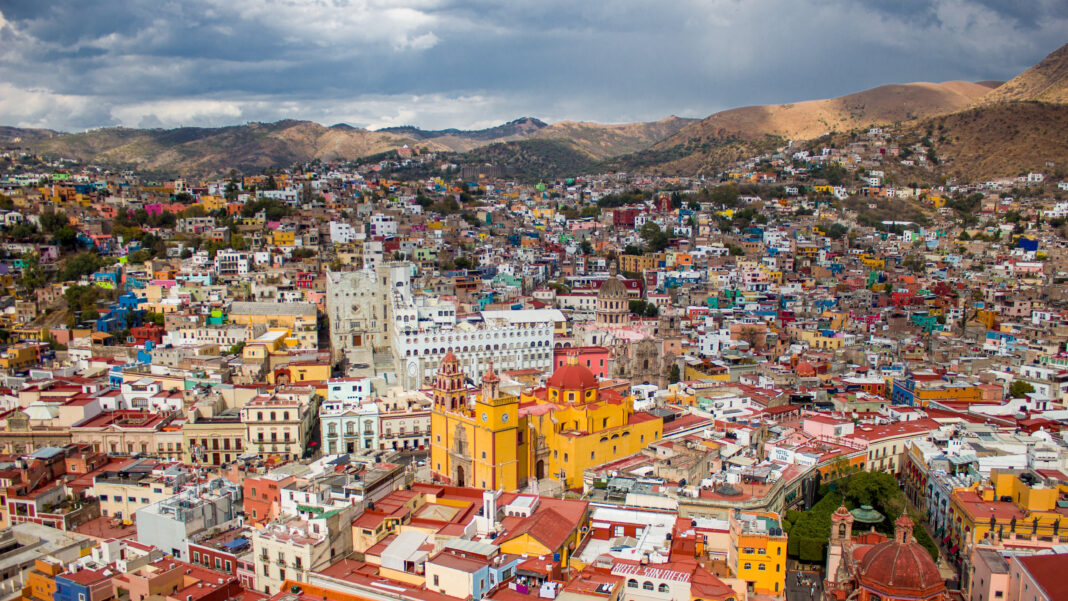 the beautiful Mexican Guanajuato city with colorful buildings surrounded by mountains